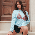 Maglia oversize azzurra con stampa airbag
